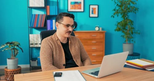 Video Call Via Webcam in Company Office Man with Glasses Sits Behind Desk in Front