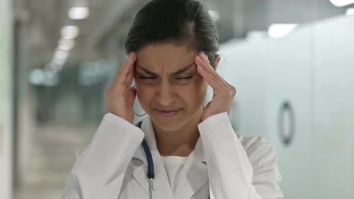 Medical Professional Experiencing Headache at Hospital