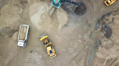 Aerial view loading bulldozer in open air quarry. Sand mining industry. Bulldozer machine. Crawler b