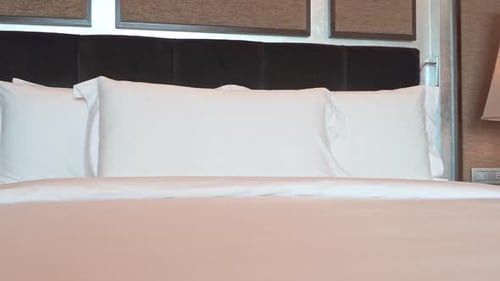 Comfortable Bed with White Sheets and Pillows