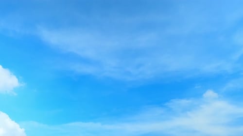 Clouds Slowly Moving Through a Blue Sky