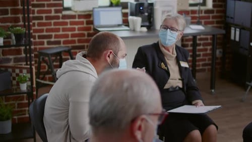 Adults at group therapy session wearing face masks