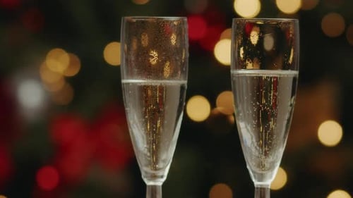 Two Champagne Glasses with Blurred Christmas Lights