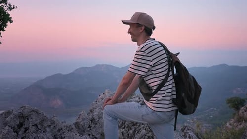 Happy Man Enjoying Seascape From Rocky Cliff Under Sundown Sky