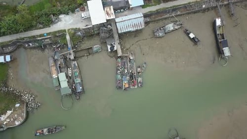 Boat mooting to a pier on a polluted river in asia