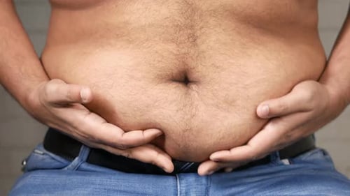 Man's Hand Holding Excessive Belly Fat Overweight Concept