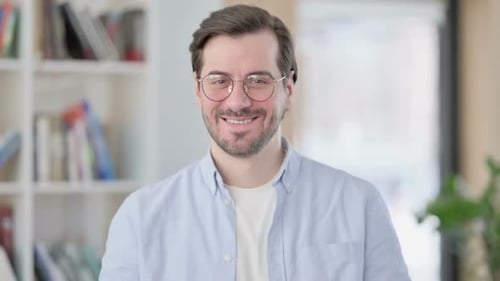 Man Talking and Waving at the Camera