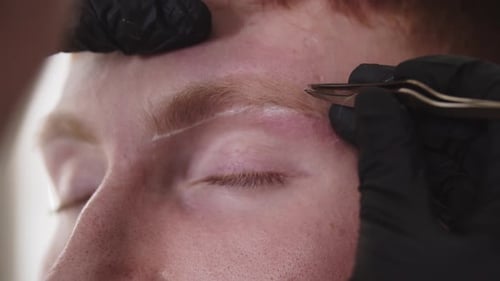 Eyebrow Shaping Treatment Using Tweezers Close Up