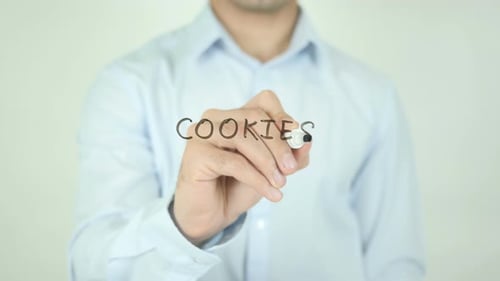 Man Writes Word Cookies on Clear Surface