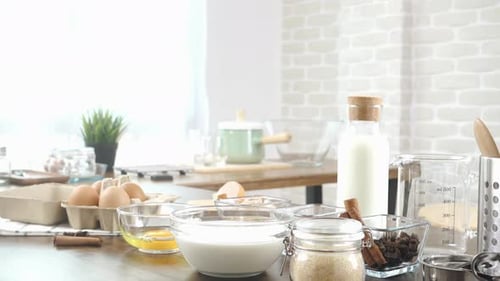 Baking Ingredients on Kitchen Table Ready for Cooking