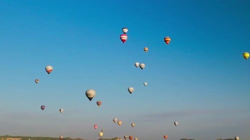 4K Aerial view of Goreme. Colorful hot air balloons fly over the valleys.