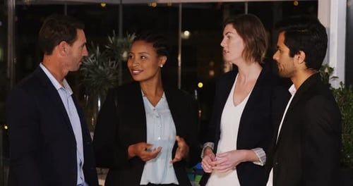 Business Professionals Talking in an Urban Office at Night