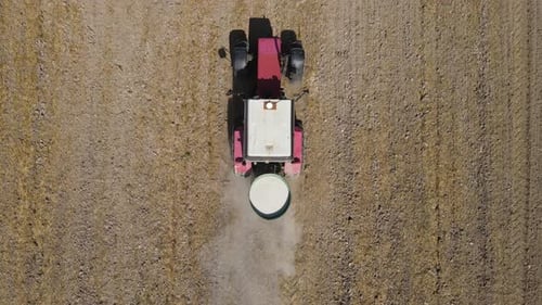 The Tractor Spreads Fertilizer To Improve The Harvest