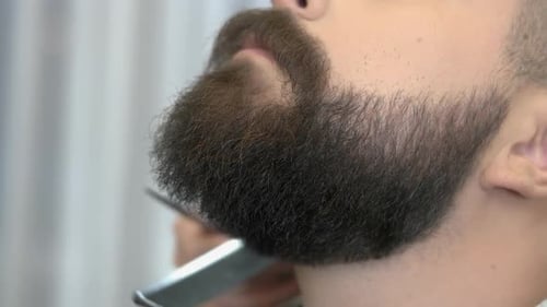 Barber Giving Man a Beard Trim Close Up