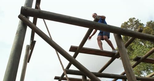 Man Navigating Obstacle Course in Natural Setting