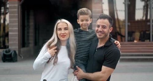 Happy Family Poses Together Outside House