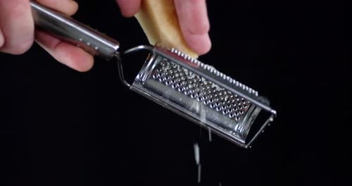 The Man Rubs Grated Parmesan Cheese To Prepare a Salad