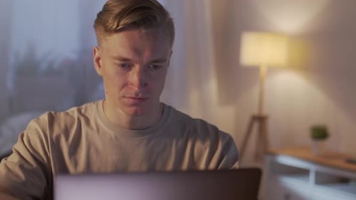 Close Up Young Man Freelancer Using Laptop Typing Scrolling Surfing Web Looking at the Screen