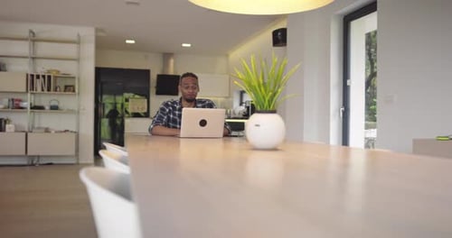Young Adult Working on Laptop at Home