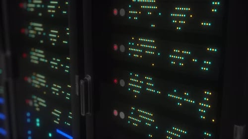 Network and data powerful servers behind glass panels in a server room of a data center or ISP.