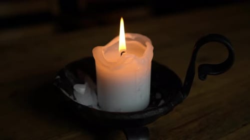 Candle in a Candlestick on a Wooden Table