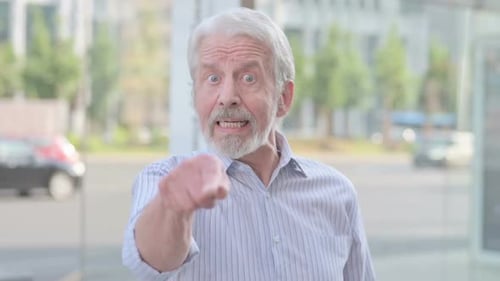 Man Speaking and Gesticulating in an Urban Setting