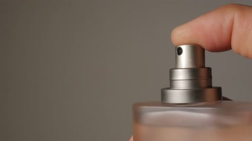 Spraying Perfume from a Glass Bottle Close Up