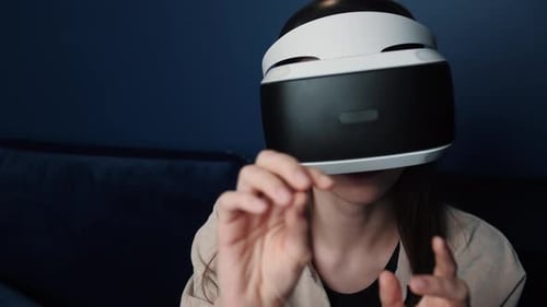 Woman Wearing VR Headset Gesturing at Home