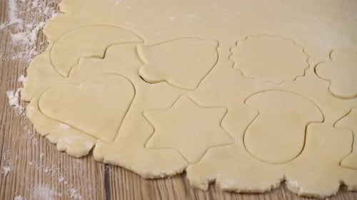 Festive Cookie Dough Cutouts on Wooden Surface