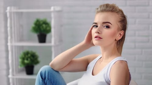 Blonde Woman Posing Elegantly in a Bright Room