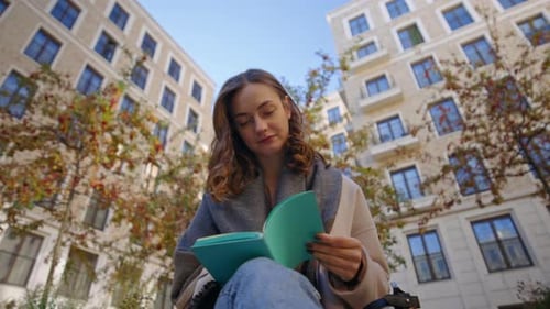 Student Make Paper Notes in Diary on Street