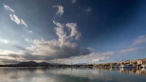 Scenic Marina Waterscape with Clouds and Coastal Buildings