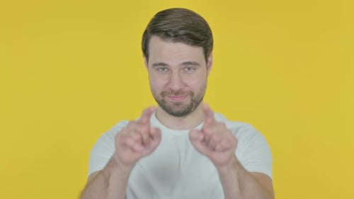 Young Man Inviting on Yellow Background