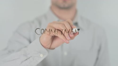 Writing Commitment with Marker on Glass Surface