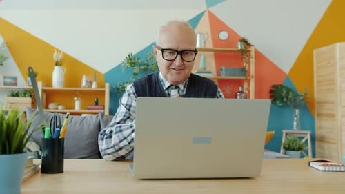 Senior Man on Video Call From Home Office