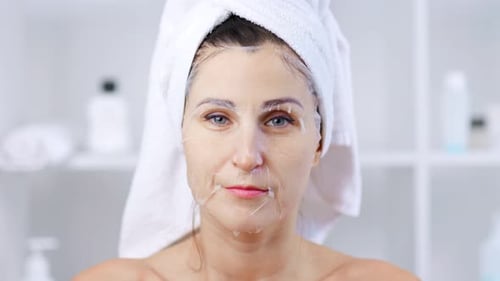 Woman Wearing Face Mask With Towel in Bathroom