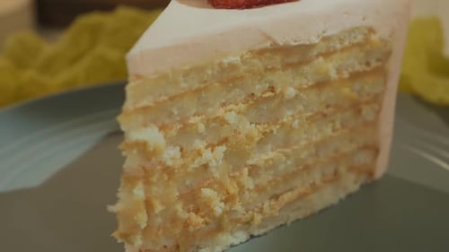 Delicious Layered Cake with Pink Frosting and Strawberry