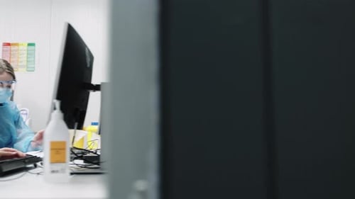 Medical Workers Typing in a Hospital Lab