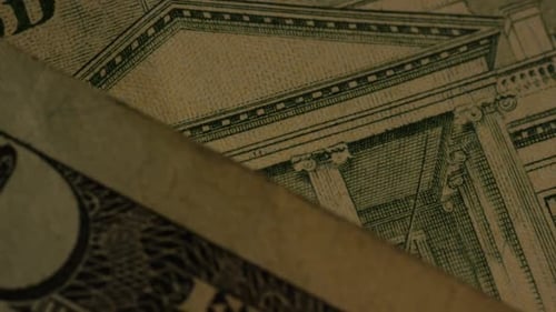 Rotating footage shot of American paper currency on an American eagle shield background - MONEY 0417