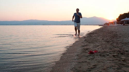 Man Running Along A Tropical Beach