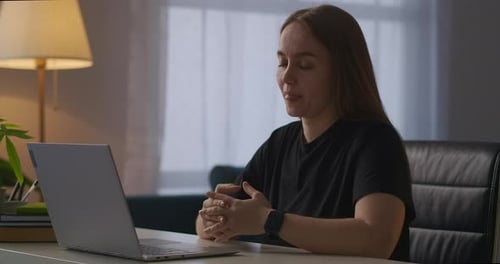 Woman Talking to Laptop During Video Conference