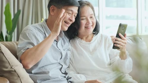Cheerful Couple Video Calling on Mobile Phone