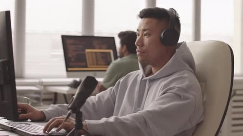 Asian Programmer Developing Video Game