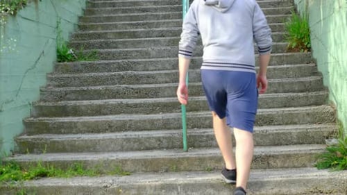 Man Walks Up Concrete Steps Outdoors