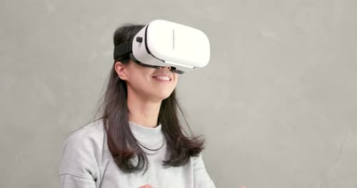 Woman Enjoys Immersive Experience Using VR Headset