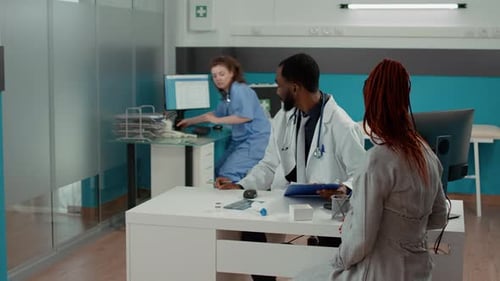 Doctor Consults with Patient in Medical Office