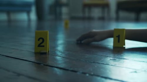 Evidence Markers Indicate Scene on Dark Hardwood Floor