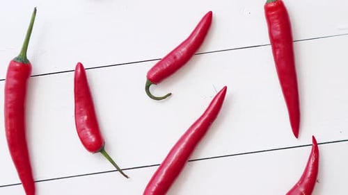 Vibrant Red Chili Peppers on White Wood Background