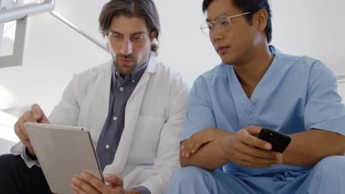 Medical Professionals Working Together on Tablet and Smartphone