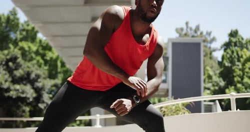 Athletic Man Stretching Legs in Urban Setting